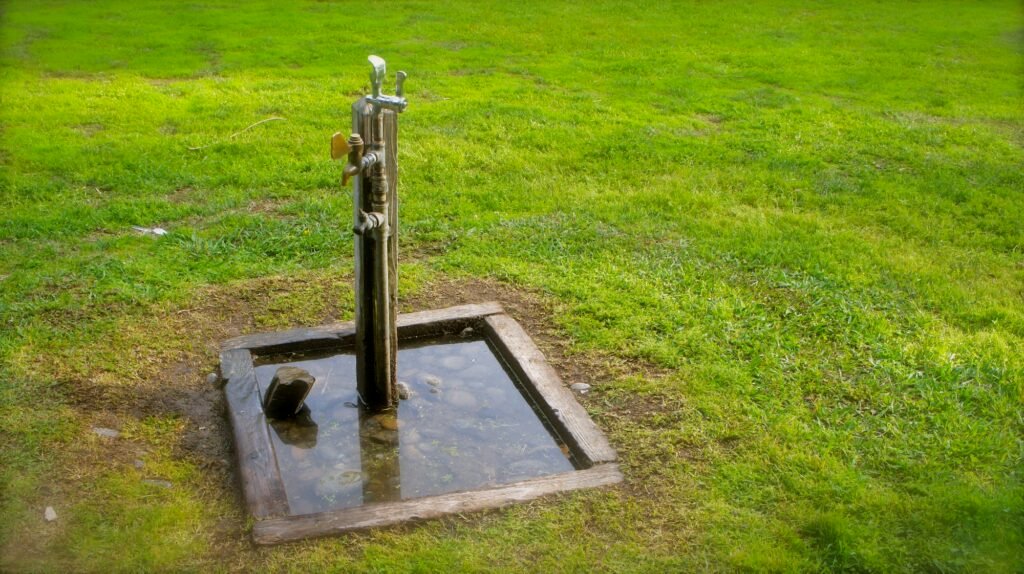 Green grass and water pump